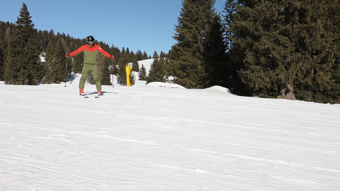 ski instructor demonstrating ski turns for beginners